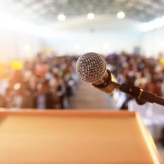 Microphone at podium, in front of blurred audience